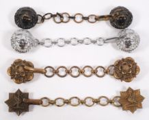 Four military cloak clasps: two with lion mask decoration,