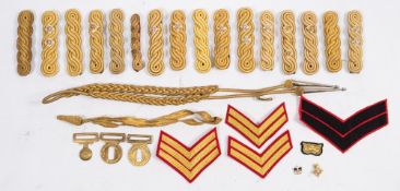 A collection of military epaulettes:, insignia etc.