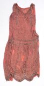 A 1920's pink cotton beaded flapper dress: profusely decorated with geometric beads (several areas
