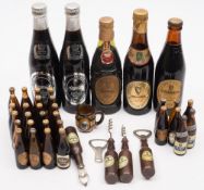 A collection of miniature Guinness bottles,