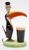 A Carlton Ware Guinness Toucan lamp:, painted in colours with advertising slogan to base,