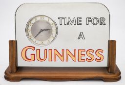 A Guinness mirror backed advertising timepiece 'Time For A Guinness':, black,