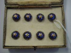 A set of eight cut steel and blue enamel buttons:,