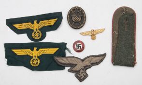 A Third Reich Period Wound badge:, together with a gilt lapel badge, an enamel NSDAP badge,