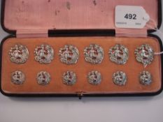 A set of twelve Victorian silver buttons:, in two sizes, of shaped outline,