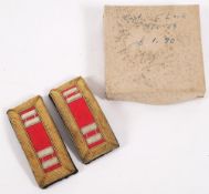 A pair of military epaulettes: of rectangular outline,