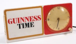 An illiumiated 'Guinness Time' clock:, 14.5 x 30cm.
