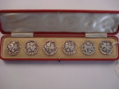 A set of six silver circular buttons:, pierced and embossed with flowerheads and foliage,