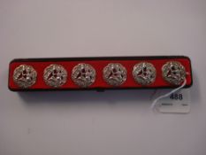 A set of six silver circular buttons:, pierced and embossed with a seated female figure,