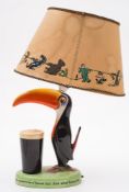A Carlton Ware Guinness Toucan lamp: with shade painted in colours with advertising slogan to base,