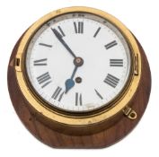 A brass cased bulkhead clock:, 8-day movement with white enamel dial and Roman numerals,