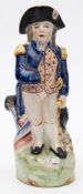 A Staffordshire pottery Nelson jug:, modelled standing in front of a cannon, 30.5cm high.