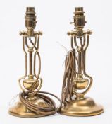 A pair of brass gimbal wall lights:, with later electrical conversion to table lamp bases,