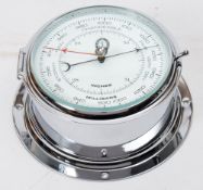 A chrome plated bulkhead barometer by J D Potter Ltd:, 20.5cm diameter.