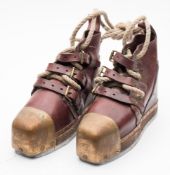 A pair of Siebe Gorman style diving boots:, brown leather uppers over brass toe caps and lead sole.