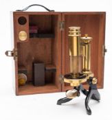 A lacquered brass monocular microscope by Stanley, London:,