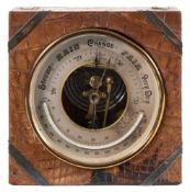 An early 20th century leather cased gilt aneroid barometer and thermometer by J C Vickery, London:,