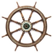 A teak, brass and iron ship's helm:, the central iron boss with block and turned spars,