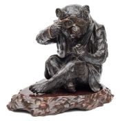 A Japanese bronze study of a monkey: seated wearing a jerkin,