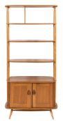 A 1960's Ercol elm and beech upright open shelf cabinet:,