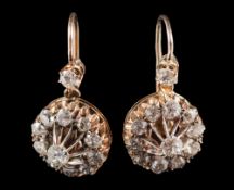A pair of gold and diamond circular cluster earrings: each with a circular cluster of old