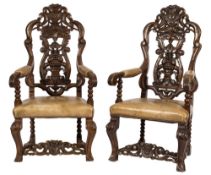 A pair of 19th Century carved oak open armchairs in the Baroque taste:,