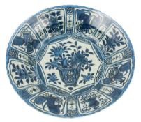 A large Chinese blue and white Kraak charger: painted with a jardiniere of flowers within a central
