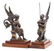 A pair of late 19th century bronze figures of seated angels: each holding a tambourine,