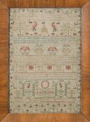 A mid 18th century needlework sampler: with banded verse, flowering shrub and bird decoration,