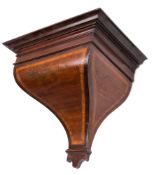 A mid-nineteenth century mahogany clock bracket: the curved tapering base with satinwood