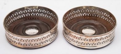 A pair of 19th century plated coasters: of circular outline with pierced sides and turned wood
