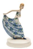 A Goldscheider figure of a dancer: modelled after the original by Stephan Dakon lifting her blue