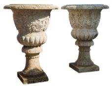 A pair of reconstructed stone garden urns:, of campagna shape,