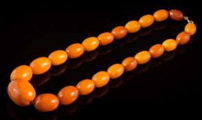A graduated amber bead single-string necklace: comprising 23 oblong beads graduated from 14mm long