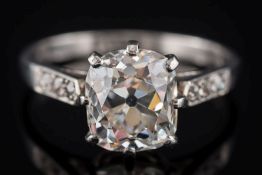 A diamond solitaire ring: the cushion-shaped old brilliant-cut diamond approximately 8.2mm long x 7.