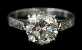 A diamond solitaire ring: the round brilliant-cut diamond approximately 8.4mm diameter x 5.