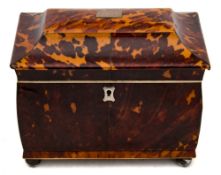 A 19th century blonde tortoiseshell tea caddy: of sarcophagus outline,