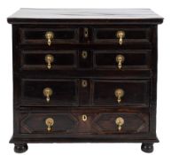 A 17th Century oak rectangular chest:, containing four long moulded and geometric panelled drawers,