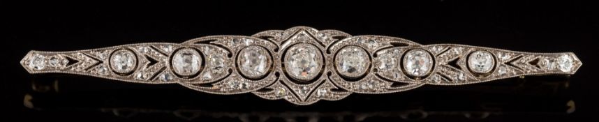 An early 20th century platinum-faced gold and diamond mounted bar brooch: of pierced elliptical