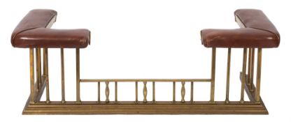 A brass club fender:, with padded corner seats upholstered in brown leather,