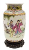 A Chinese porcelain vase: decorated in the famille rose palette with two female figures holding