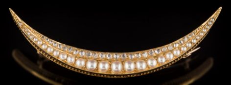 A late 19th/early 20th century rose diamond and half pearl mounted crescent brooch: with graduated