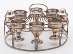 An old Sheffield plate egg cup stand: the oval-shaped cage with reeded decoration,