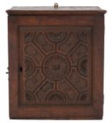 A late 17th/early 18th Century oak wall cabinet:, with a moulded cornice,