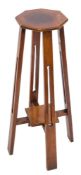 An Arts and Crafts mahogany octagonal jardiniere stand:, on quadruple openwork splayed supports,