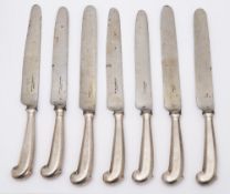 Eleven 19th century pistol handled table knives: crested, with steel blades and filled handles.