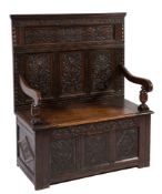 A carved oak box settle:,