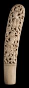A Burmese or Thai ivory dha hilt: carved in high relief to each side with a demon holding aloft a
