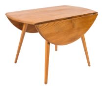 A 1960's Ercol elm and beech oval drop flap dining table:,