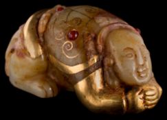 A Chinese jade and applied gold crouching figure: in traditional costume, with applied paste stones,